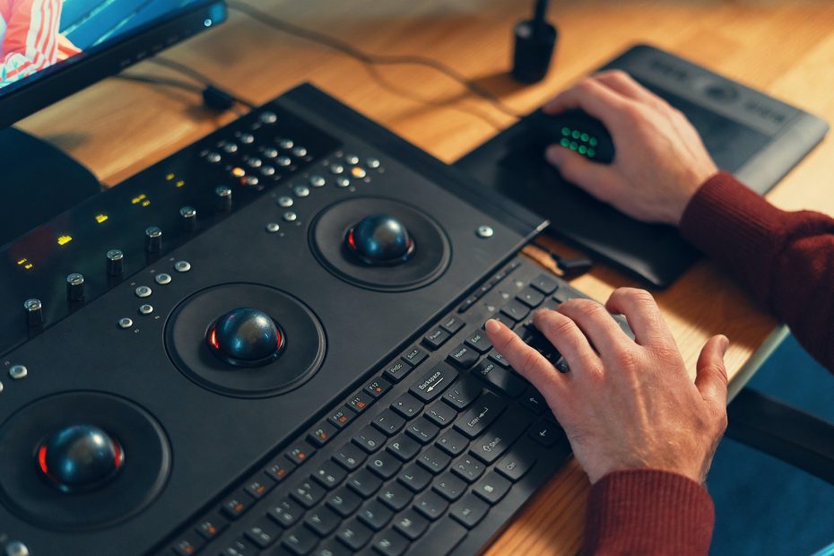 Video editor hands adjusting color or sound on working console machine